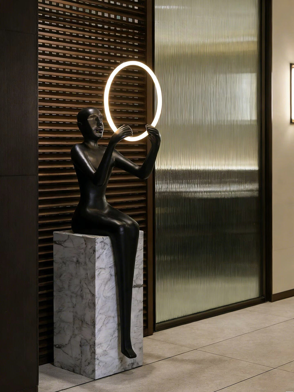 Hand held circular abstract sitting posture statue floor lamp